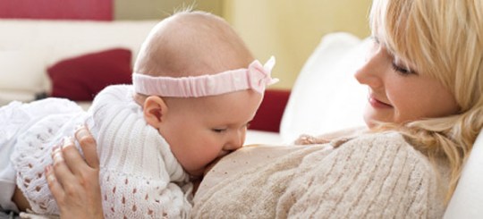 Mother breast feeding her baby girl