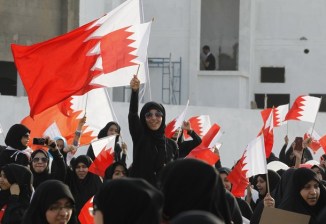 Shi'ite Bahraini protesters wave Bahrain flags during an anti-government gathering in Jidhafs village, east of Manama