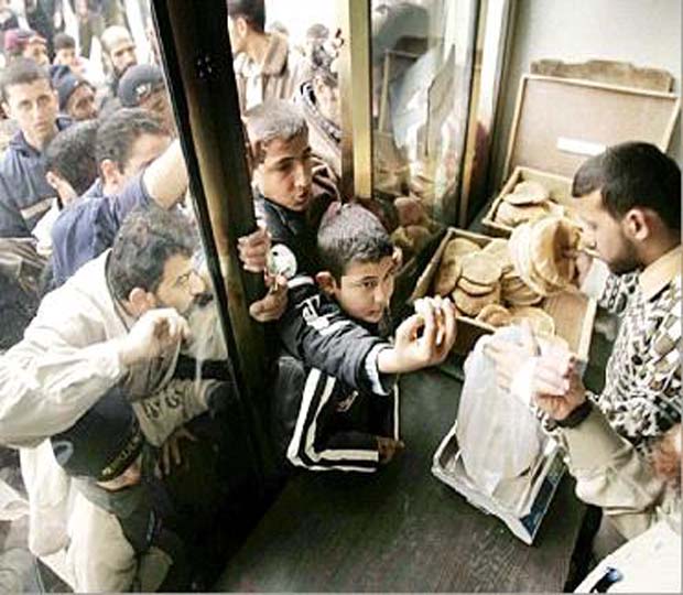 Syrian Refugee takes Bread at Camps