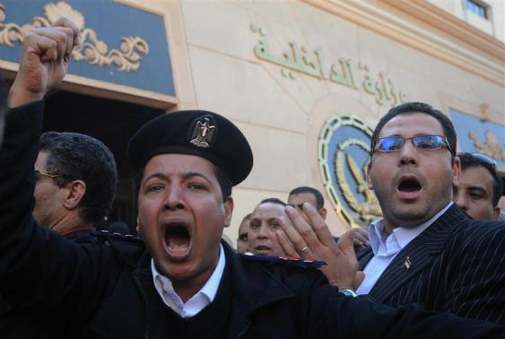 Police officers take part in a sanctioned protest outside the Interior Ministry building in Cairo
