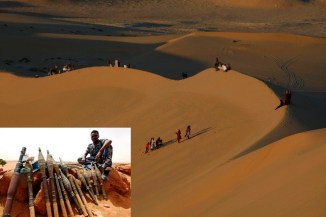 Residents walk on sand dunes in the Libyan desert oasis town of Ghadames