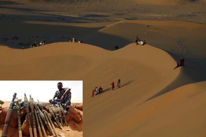 Residents walk on sand dunes in the Libyan desert oasis town of Ghadames