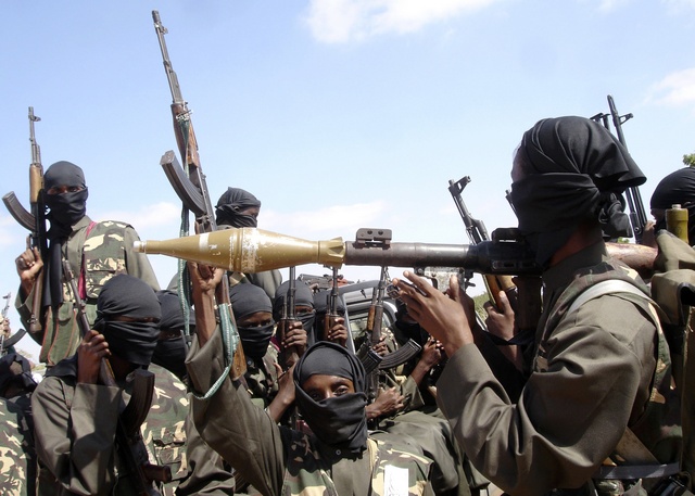 Militants of al Shabaab display their weapons on the outskirts of Mogadishu