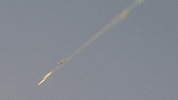 A Syrian Air Force fighter plane fires a rocket during an air strike loyal to Syria's President Bashar al-Assad in Raqqa province, eastern Syria