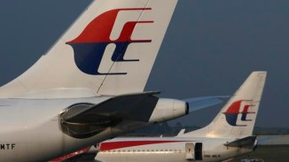 Malaysia Airlines planes sit on the tarmac at Kuala Lumpur International Airport