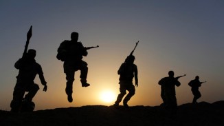 Shi'ite volunteers patrol the area as they secure it against the predominantly Sunni militants from the Islamic State in the desert region between Kerbala and Najaf
