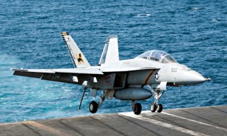 A US warplane lands on an aircraft carrier in the Gulf after bombing Islamic State targets in Syria