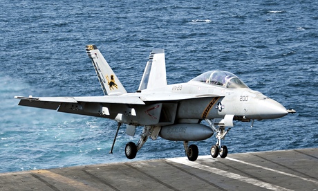 A US warplane lands on an aircraft carrier in the Gulf after bombing Islamic State targets in Syria