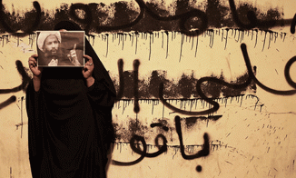 Bahraini Woman Holds Photo of Saudi Shia Cleric Nimr Baqar Al Nimr