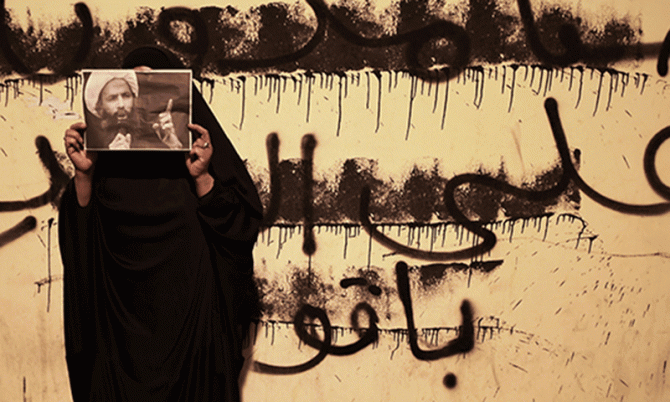 Bahraini Woman Holds Photo of Saudi Shia Cleric Nimr Baqar Al Nimr