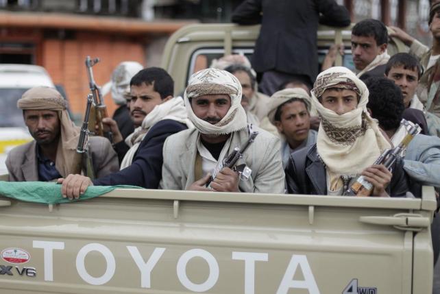 File photo shows Shi'ite Houthi rebels riding a patrol truck in Sanaa
